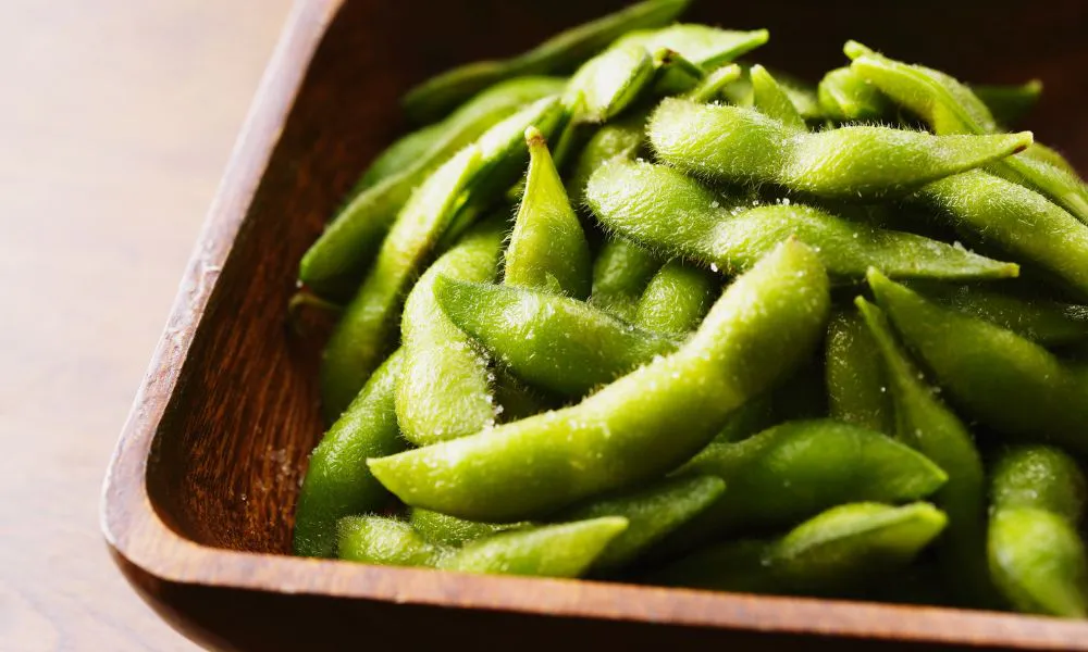 Steamed edamame beans sprinkled with salt, served in a wooden bowl at Blue Coast Asian Cuisine, a Asian restaurant in Davenport