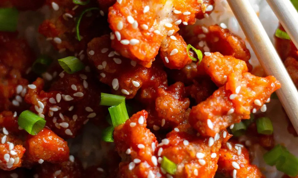 Crispy orange chicken glazed with sweet sauce, topped with sesame seeds and green onions at Blue Coast Asian Cuisine, a Asian restaurant in Davenport